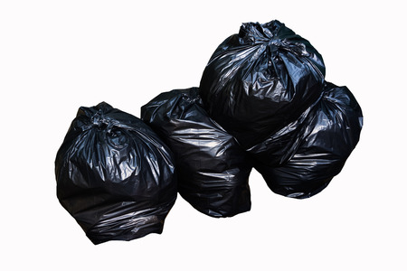 Black garbage pile in the bag on white backgroundの写真素材