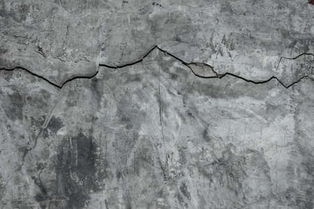 Grunge concrete cement wall with crack in industrial building, great for your design and texture backgroundの写真素材