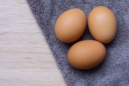 Fresh eggs on wooden and Microfiber Cloth backgroundの写真素材