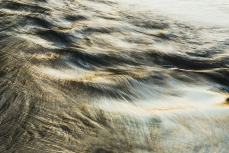 Water background with sea low angle view, river, wave. Close up nature background. Soft focus with selective focus blur.の写真素材