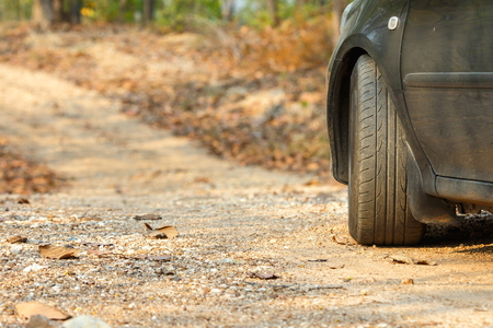 back side of car parking on the Dirt road /mountain road/country road in Forest in Thailand.の写真素材