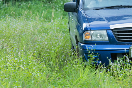 Car blue in the grass,Driving in the grass, Car Drivin in the countryside.の写真素材