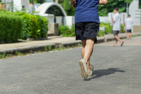 Exercising in the park,jogging and running outdoors in nature,jogging workout wellness concept.の写真素材