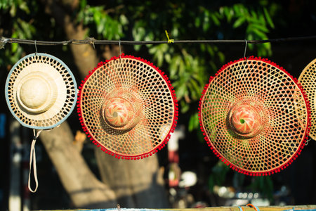 Bamboo woven hats are a long-held tradition of Thai wisdom, using local materials to create benefits,Straw hats for sale at a market in Thailand. Selective focus.の写真素材
