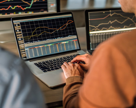Close-up of businessman working with laptop and analyzing stock market , Chart Forex Trading...