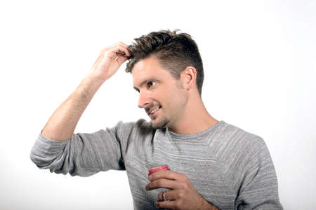 man applying hair product