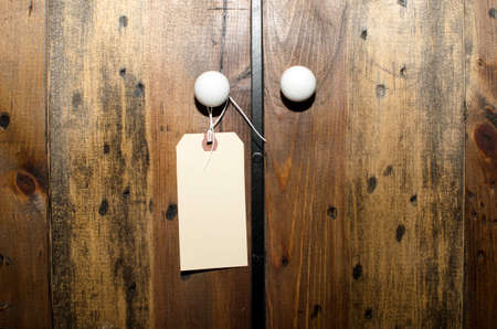 Wooden doors with a blank tag hanging off handle の写真素材