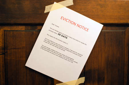 An eviction notice taped to a door の写真素材