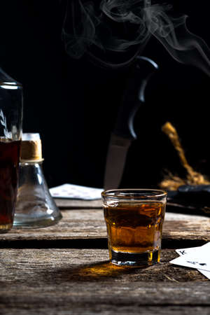 An abstract drinking scene with playing cards and a knife の写真素材