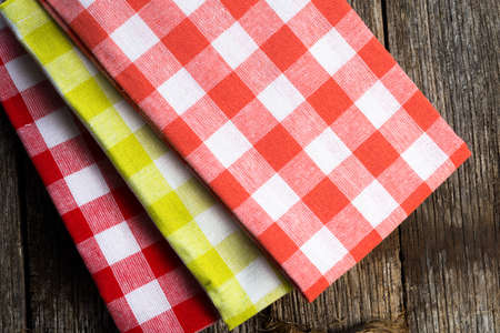 Checkered cloth napkins on a rustic wood surface の写真素材