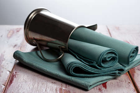 Green cloth napkins on a worn wood surface の写真素材