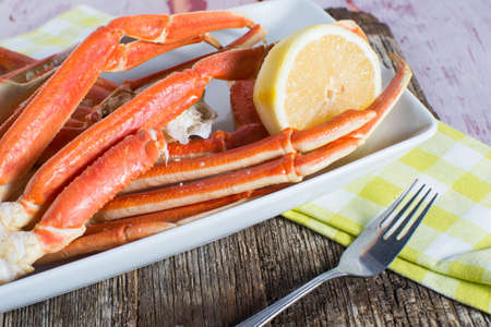 Steamed snow crab legs with lemon seafoodの写真素材
