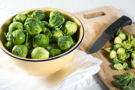 Yello bowl of fresh cut brussel sprout vegetablesの写真素材