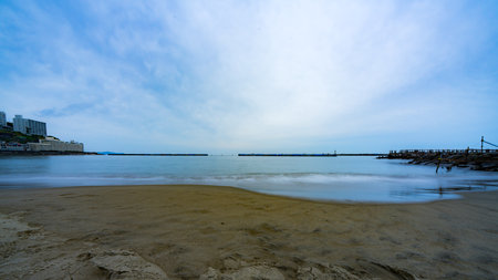 Long exposure of the beach with blue sky and cloud in the morningの写真素材