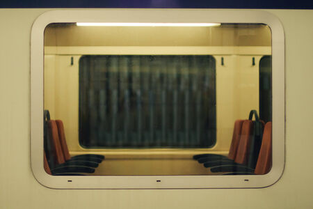 Window of a train with view of seats insideの写真素材