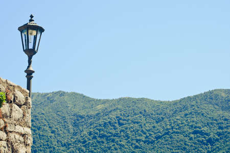 Vintage lantern and mountain view in Montenegro