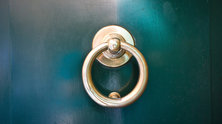 Golden handle on the green door