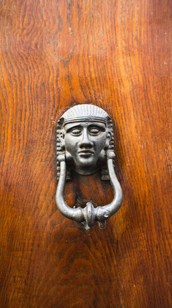 Pseudo antique bronze knocker in the form of egypt human headの写真素材