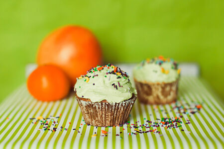 Coloured cupcakes with orange on backgroundの写真素材
