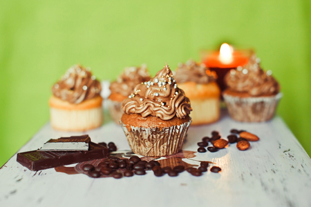 Chocolate cupcakes with chocolate, candle and nutsの写真素材