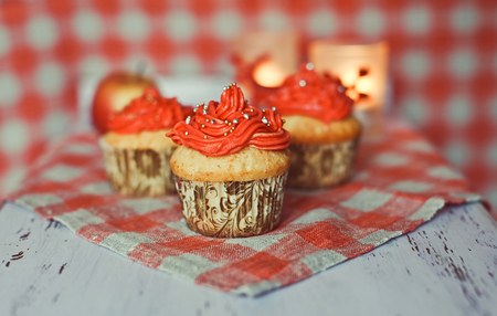 Cupcakes with candies, apple and candleの写真素材