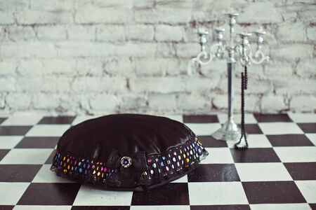 Black pet place with candlestick on the black and white floorの写真素材