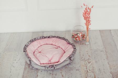 Pink and gray pet mattress with flowers in interiorの写真素材
