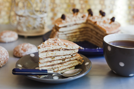 Closeup piece of a cake with tea in grey cupの写真素材