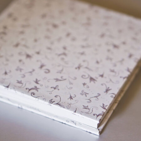 Closed white book with abstract decoration