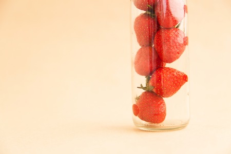 Tasty closeup strawberries in the bottleの写真素材