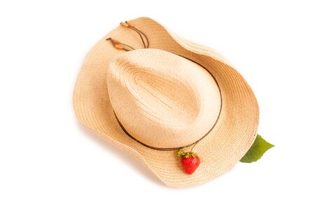 Summer background: strawberry, green leaf and hat isolated on whiteの写真素材