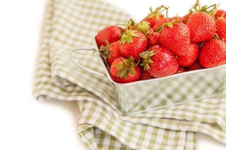 Fresh strawberry in a metal box isolated on white backgroundの写真素材