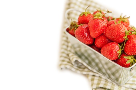 Tasty organic strawberries in the metal box isolated on whiteの写真素材