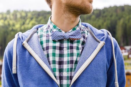 Young bearded gentleman in shirt with casual bowtie and nature on backgroundの写真素材
