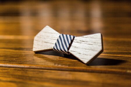 Vinatge classic wooden bowtie lying on tableの写真素材