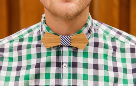 Portrait of casual business man in plaid shirt and wooden bowtieの写真素材