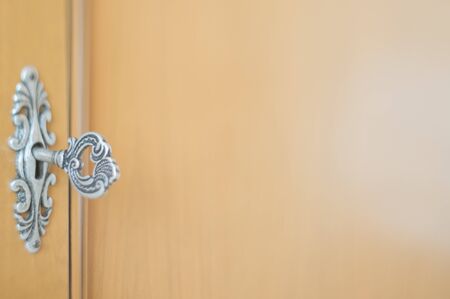 Close-up photo of an obsolete key inside a keyholeの写真素材
