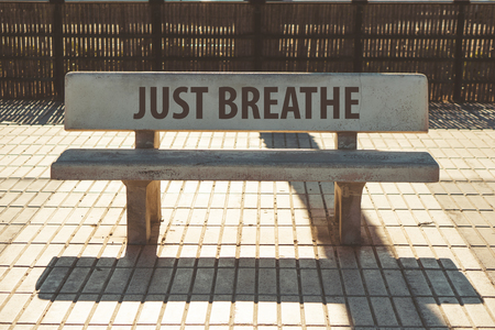 Just breathe text on a bench on the pedestrian part of mediterranean cityの写真素材