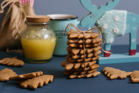 Ginger cookies with honey, tea and moose on the dark blue backgroundの写真素材