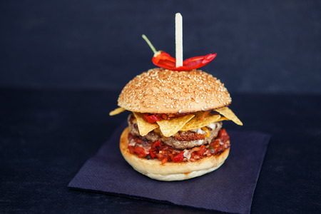 Streetfood mexican burger with red paper on the black backgroundの写真素材