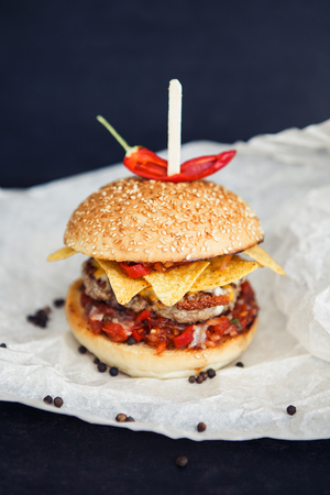 Streetfood mexican burger with red paper on the black backgroundの写真素材