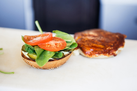 Making vegetarian burger with cheese on the white backgroundの写真素材