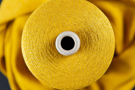 Yellow colour skein on the textile background