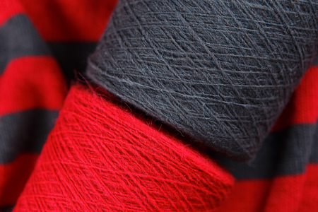 Red and grey colour skeins on the textile background
