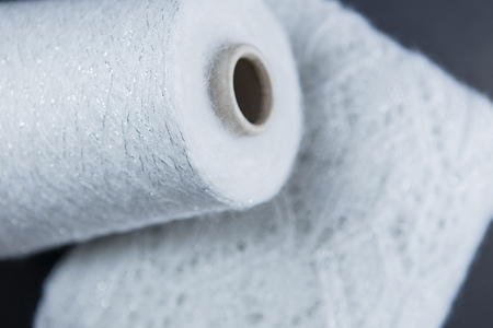 White and silver colour skein and textile on the black backgroundの写真素材