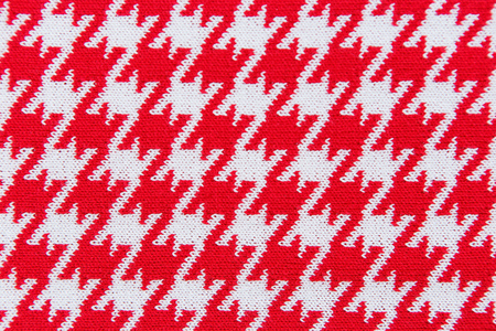 Close-up knitted textile pattern in red and white colors as backgroundの写真素材