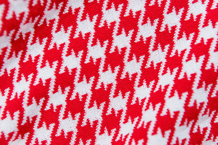 Knitted red and white colors textile pattern as background