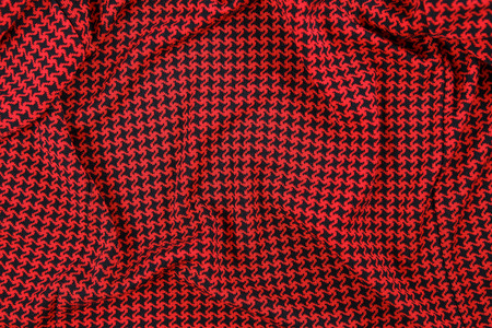 Knitted textile pattern in red and black colors as background