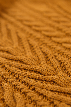 Closeup orange color cotton knitted textile with pattern as background