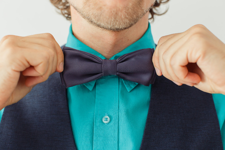 Man in green shirt with beard wearing bowtie, hipster style